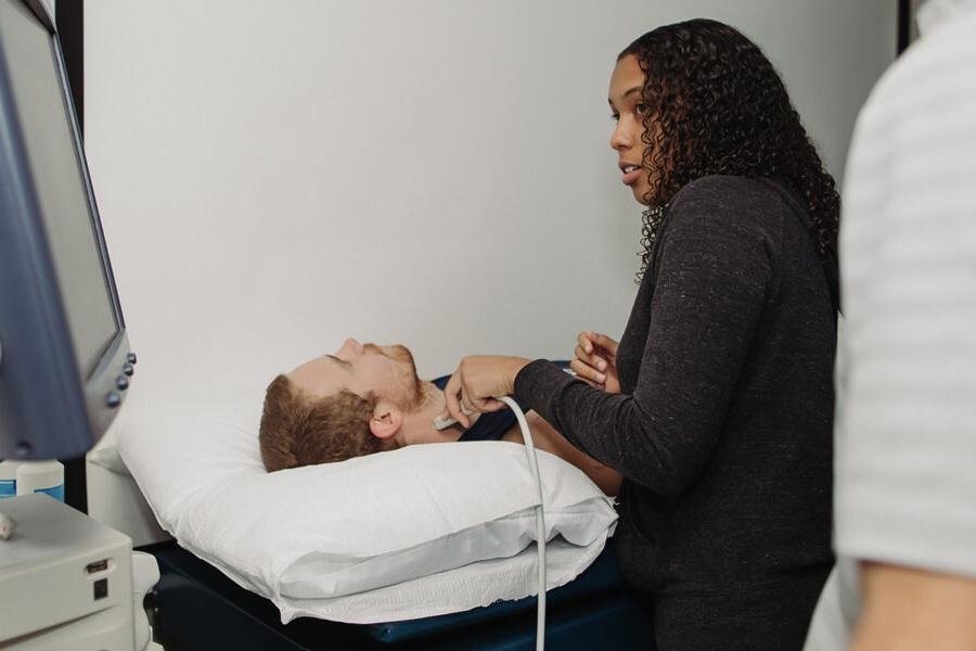 a health student performing a test on a patient